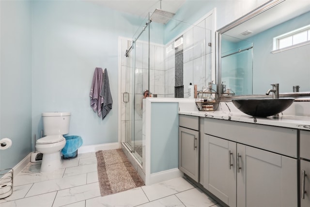 bathroom with toilet, vanity, and walk in shower