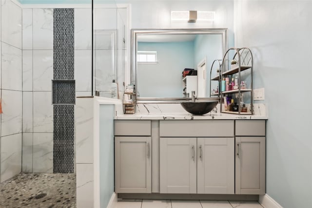 bathroom featuring tiled shower, vanity, and tile patterned floors