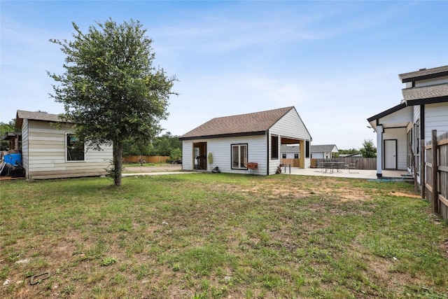 287 La Fortuna Dr, Del Valle, TX 78617 - rear view of property with a patio and an outdoor structure