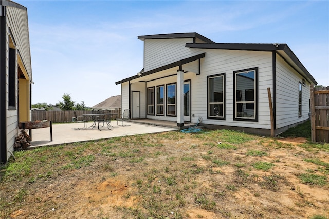 back of property featuring a yard and a patio