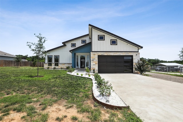 modern inspired farmhouse featuring a front yard and a garage