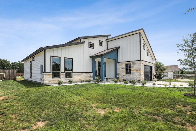 287 La Fortuna Dr, Del Valle, TX 78617 - modern home with stone siding, board and batten siding, and an attached garage