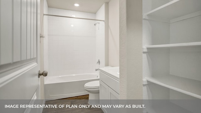 full bathroom with vanity, hardwood / wood-style floors, tiled shower / bath, and toilet