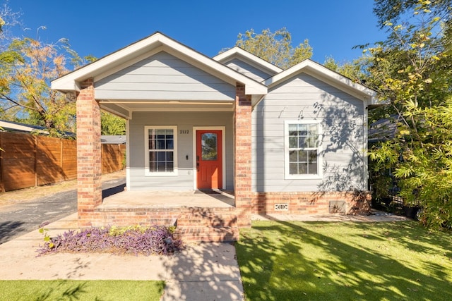 view of front facade with a porch and a front lawn