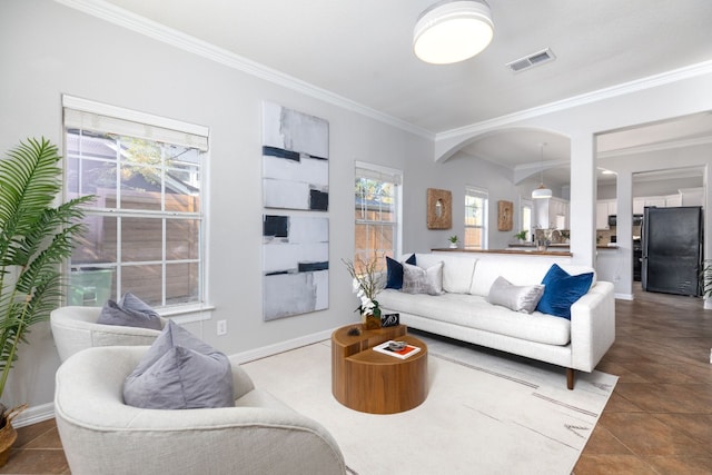 living room with crown molding and dark tile patterned floors