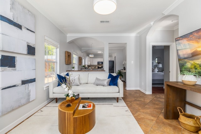 living room with ornamental molding and light tile patterned flooring