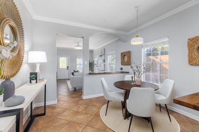 dining room with ornamental molding and light tile patterned flooring