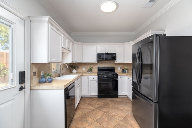 kitchen with white cabinetry, sink, crown molding, decorative backsplash, and black appliances