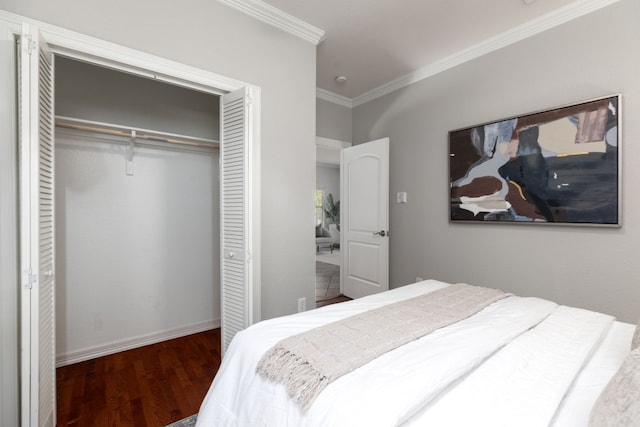 bedroom featuring a closet, dark hardwood / wood-style flooring, and ornamental molding