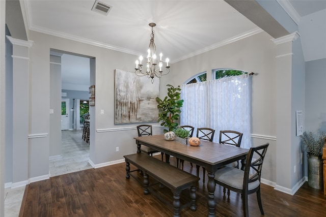 dining area with hardwood / wood-style floors, a healthy amount of sunlight, and decorative columns