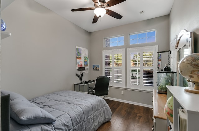 bedroom with ceiling fan and dark hardwood / wood-style flooring