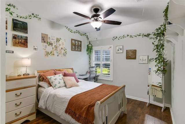 bedroom with dark hardwood / wood-style flooring and ceiling fan