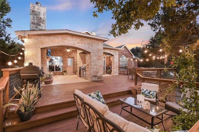 deck at dusk with an outdoor hangout area