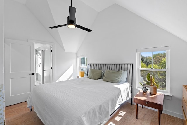 bedroom featuring ceiling fan, light hardwood / wood-style flooring, and lofted ceiling