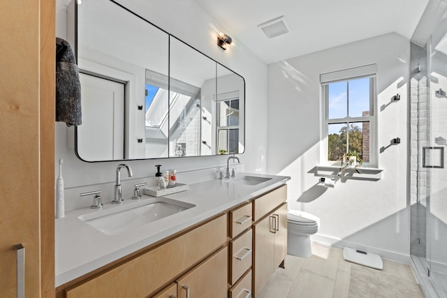 bathroom with tile patterned floors, vanity, toilet, and walk in shower