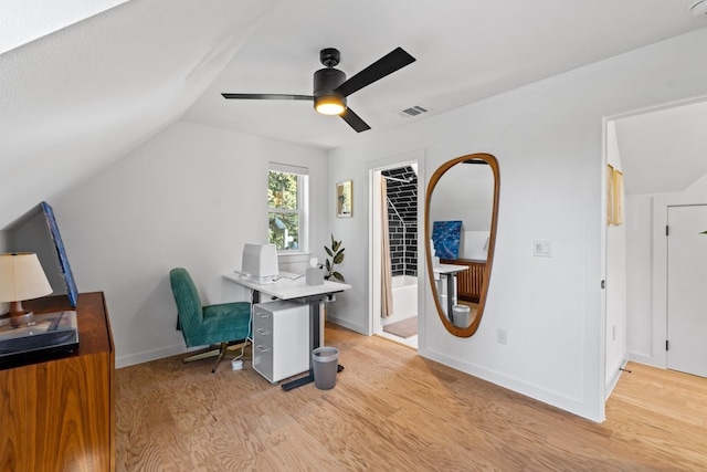 office area featuring light wood-type flooring, vaulted ceiling, and ceiling fan