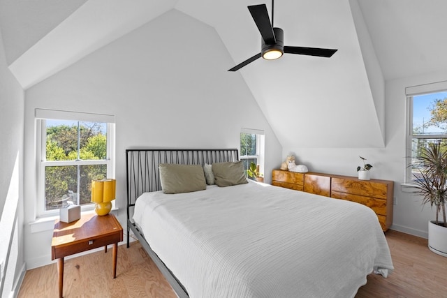 bedroom featuring ceiling fan, light hardwood / wood-style floors, and vaulted ceiling