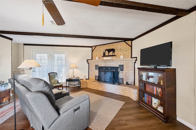 living room featuring ceiling fan, dark hardwood / wood-style flooring, lofted ceiling with beams, and a textured ceiling