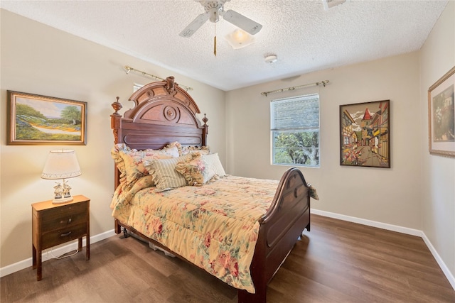 bedroom featuring ceiling fan, dark wood-type flooring, and a textured ceiling