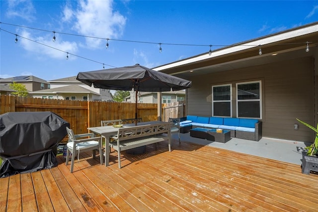 wooden terrace with an outdoor living space and grilling area