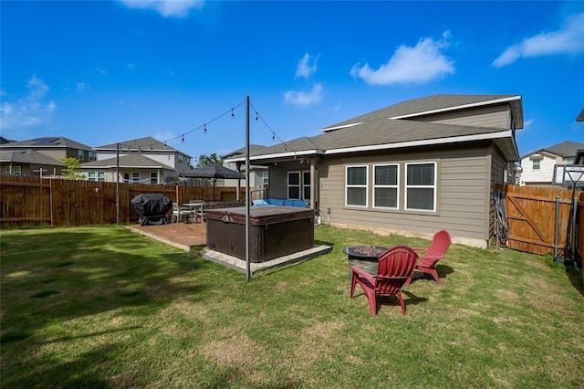 11303 Copper Spring Dr Unit 87, Austin, TX 78748 - back of house with a hot tub, a fenced backyard, and a fire pit