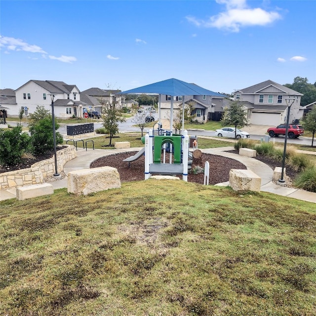 view of property's community featuring a yard and a playground