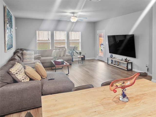 living room with ceiling fan, wood-type flooring, and vaulted ceiling