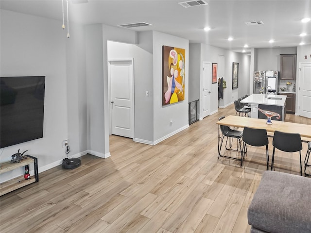 living room featuring light hardwood / wood-style flooring and sink