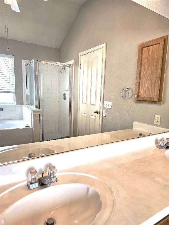 bathroom with vanity, separate shower and tub, ceiling fan, and lofted ceiling