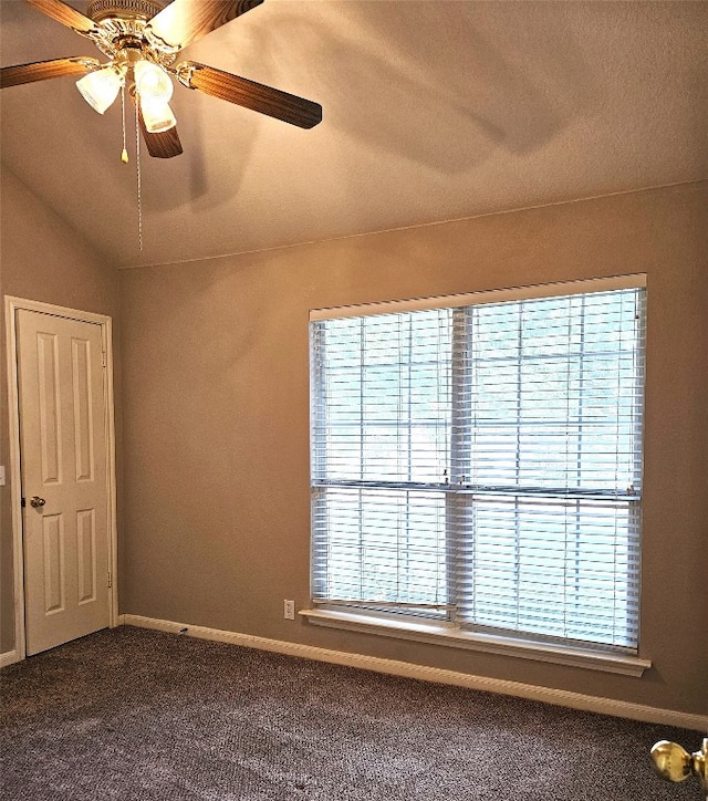 carpeted spare room with a textured ceiling, ceiling fan, and lofted ceiling