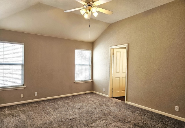 carpeted spare room with a wealth of natural light, ceiling fan, and lofted ceiling