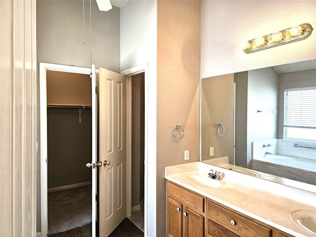 bathroom with vanity and a bath