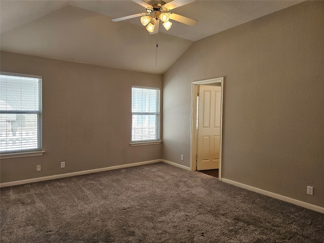 carpeted empty room featuring ceiling fan and lofted ceiling