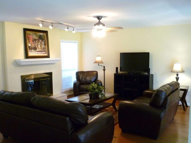 living room with wood-type flooring and ceiling fan