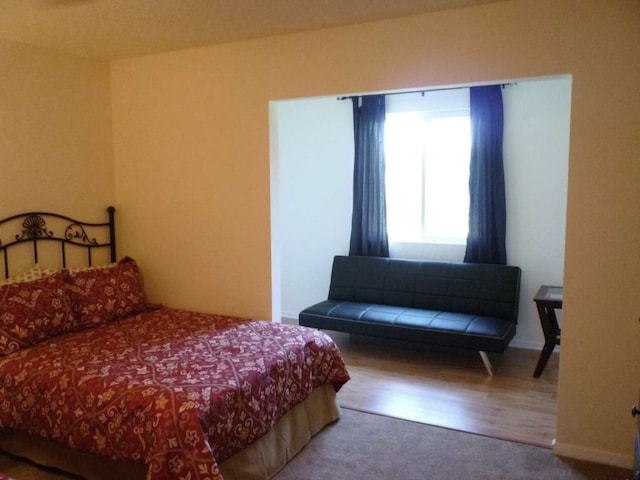 bedroom with hardwood / wood-style flooring