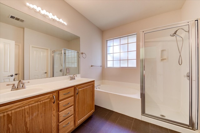 bathroom with vanity and shower with separate bathtub