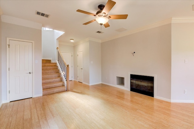 unfurnished living room featuring ceiling fan, light hardwood / wood-style floors, and ornamental molding