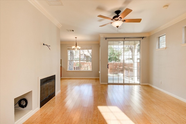 unfurnished living room featuring ceiling fan with notable chandelier, light wood-type flooring, and ornamental molding