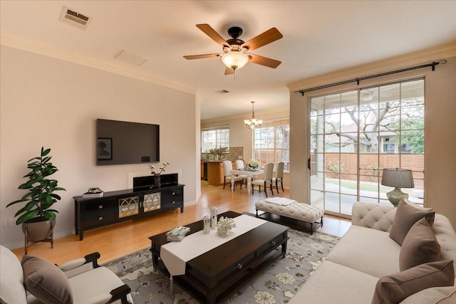 11000 Anderson Mill Rd Unit 9, Austin, TX 78750 - living area featuring crown molding, a chandelier, a ceiling fan, and light wood-type flooring