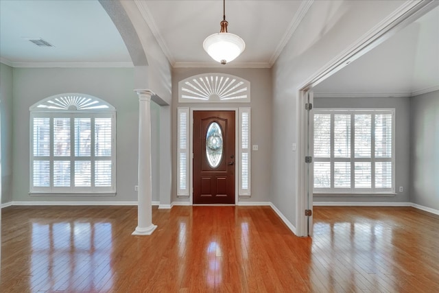 foyer with ornate columns, crown molding, and light hardwood / wood-style flooring