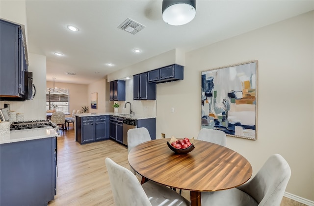 dining space featuring light hardwood / wood-style flooring and sink