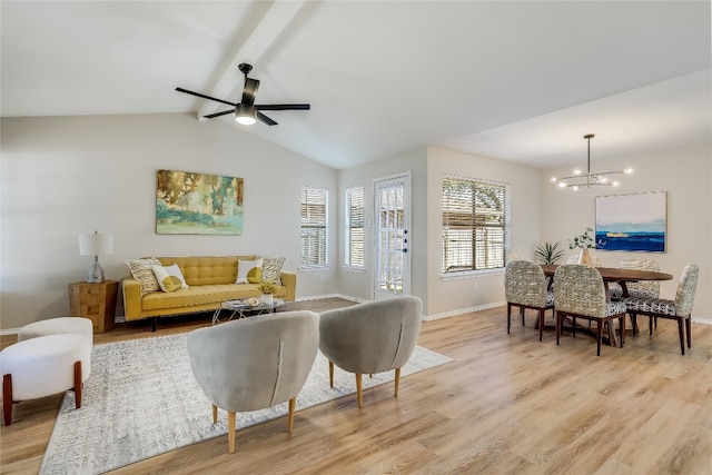 living room featuring light hardwood / wood-style flooring, lofted ceiling with beams, and ceiling fan with notable chandelier