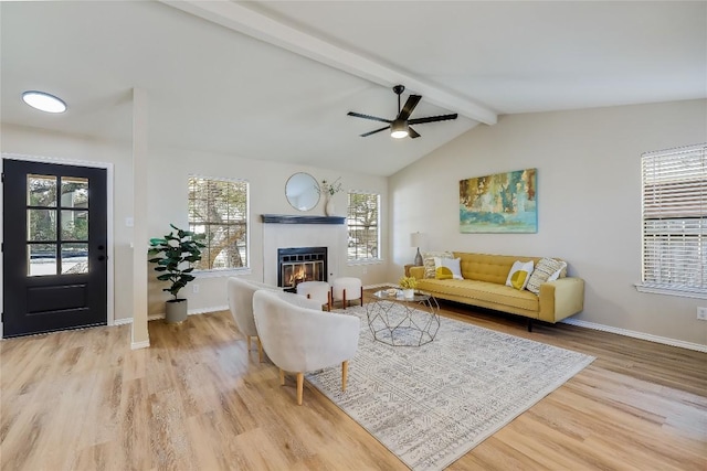 living room featuring lofted ceiling with beams, ceiling fan, and light hardwood / wood-style floors