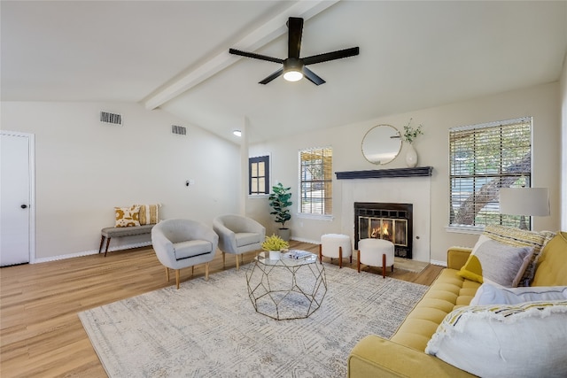 living room featuring hardwood / wood-style floors, lofted ceiling with beams, and ceiling fan