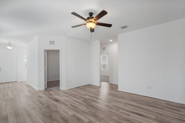 unfurnished living room featuring ceiling fan and light hardwood / wood-style floors