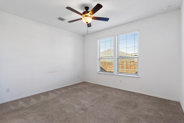 carpeted spare room featuring ceiling fan