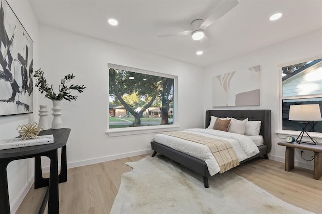 bedroom featuring light hardwood / wood-style floors and ceiling fan