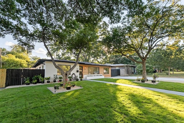 ranch-style house with a front lawn