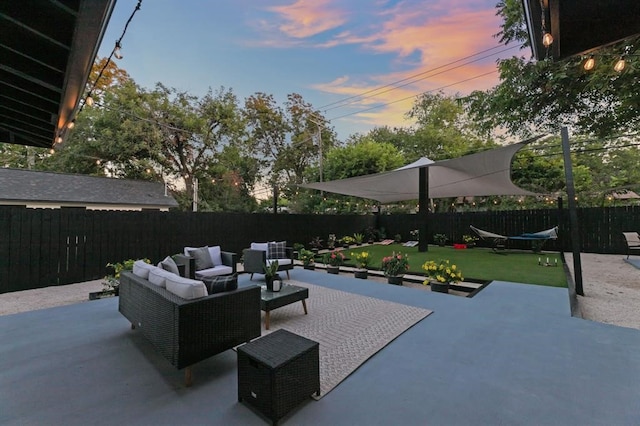 patio terrace at dusk with a lawn and an outdoor living space