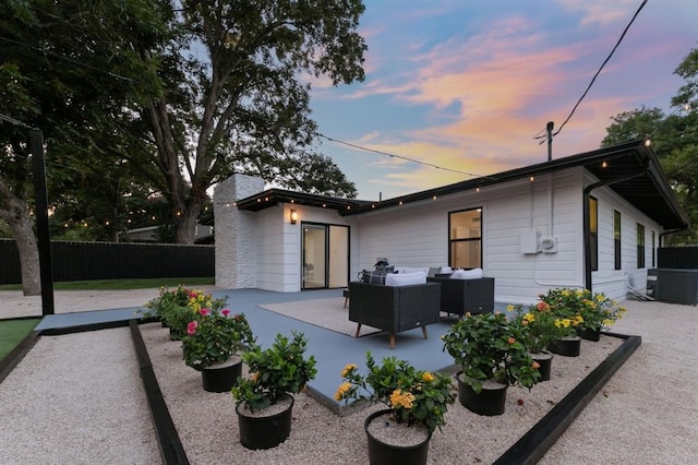 property exterior at dusk featuring a patio area and an outdoor hangout area